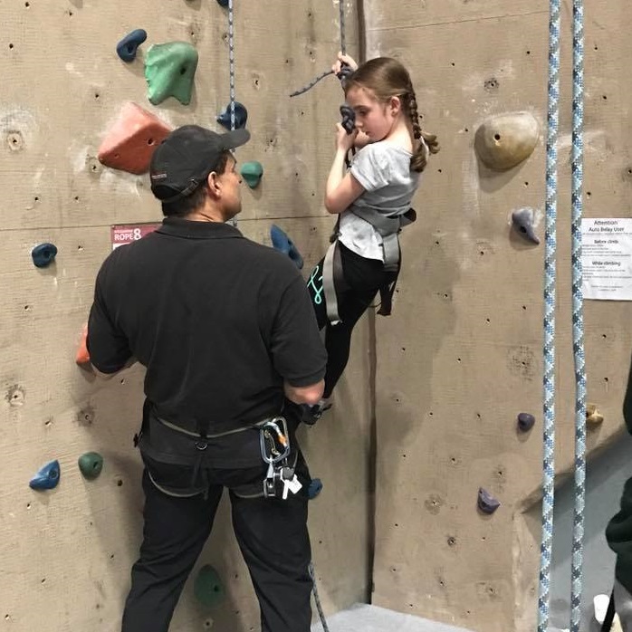 Young climber learning to climb